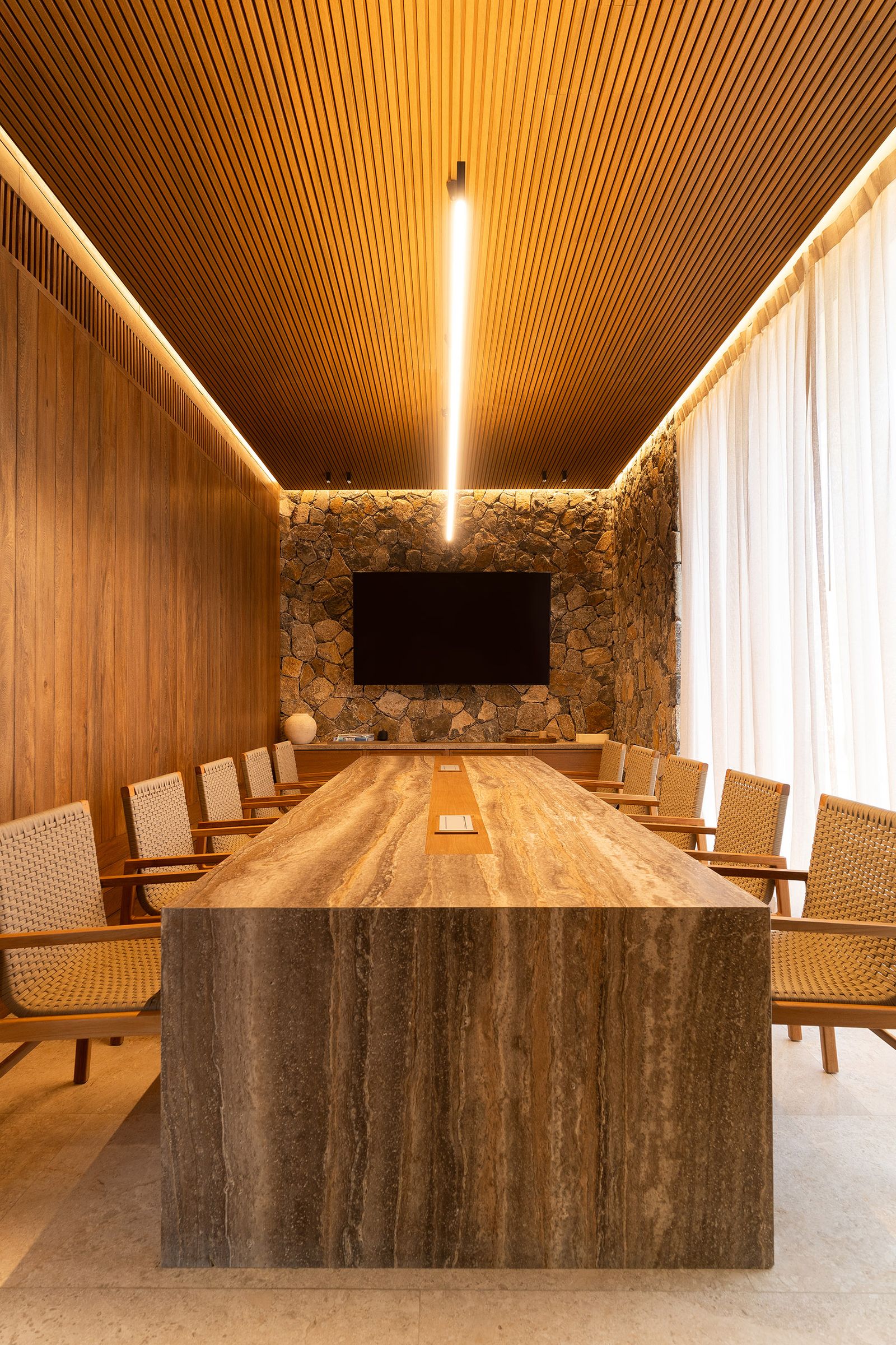 Sala de juntas del showroom de Maena en Punta Mita con plafón de madera